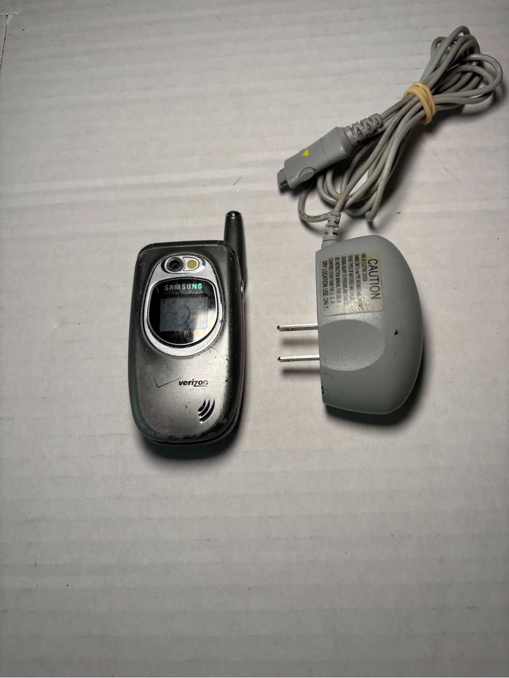 Samsung Silver and Gray Flip Phone with Matching Charger